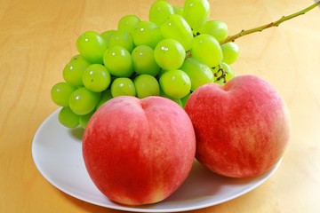 Peaches and green grapes on the table