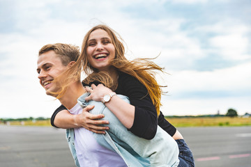 Happy couple having fun and enjoying a piggyback ride
