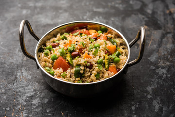 Broken wheat or Daliya Upma, served in a bowl. selective focus