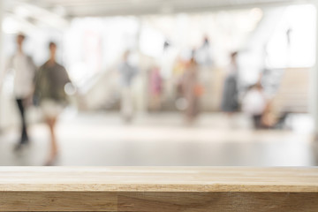 Empty wooden Brown table and blurred subway station background. Mock up for display or montage of product,Business presentation.
