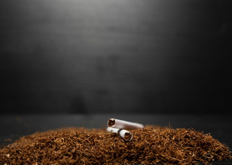 Raw tabaco on black wood background with copy space for text