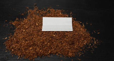 Raw tabaco on black wood background with copy space for text