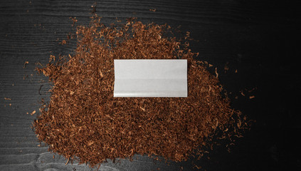 Raw tabaco on black wood background with copy space for text