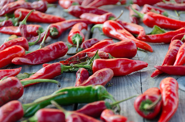 Raw organic chili red peppers on wooden backgtound