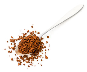 Spoon of instant coffee is scattered on a white background. The view of the top.