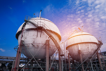 Gas storage sphere tanks in oil and gas refinery industrial plant on blue sky with white cloud background