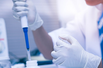 scientist using auto-pipette with Eppendorf consumables tube in the lab,Doing experiment for product,The researchers analyzed to find the results of the experiment.