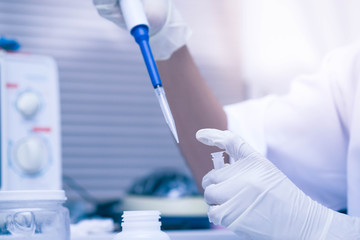 scientist using auto-pipette with Eppendorf consumables tube in the lab,Doing experiment for product,The researchers analyzed to find the results of the experiment.