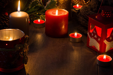 Christmas candles on wooden table. Dim light. Copy space