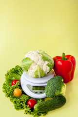 Fresh vegetables on vase on yellow background. Healthy eating, diet planning, weight loss, detox, organic farming concept
