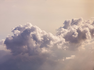 storm clouds puffy above view through the sunset