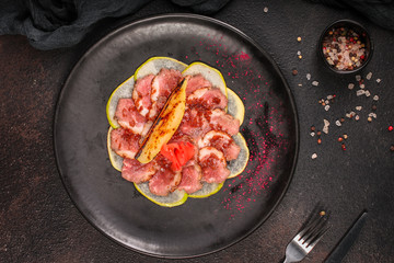 duck meat carpaccio with pear flambe (tasty snack, aperitif) menu concept. food background. copy space. Top view