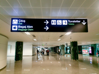 toilet exit baggage claim direction signs at the airport