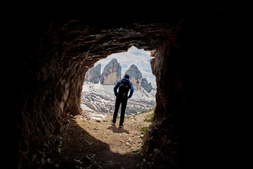 Obraz premium A hiker with Tre Cime di Lavaredo in the background, Dolomites, Italy