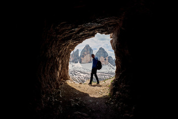 Obraz premium A hiker with Tre Cime di Lavaredo in the background, Dolomites, Italy