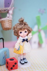 Cute BJD doll. BJD stands for Ball-Jointed-doll. A doll dress up in lovely yellow dress and curled...
