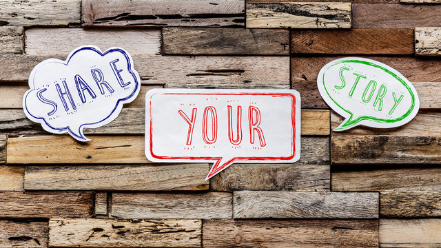 Speech bubbles on wooden background : share your story