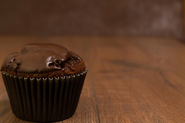 Chocolate muffin on a brown table