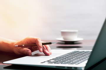 man using laptop computer working on new project idea at desk in office