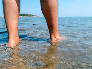 tourist man at the beach go into the sea