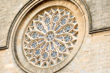 Alcudia. Rosette on the wall of the Catholic Church