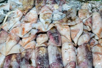 Fresh Squid on a market stall. Closeup fresh squid on the market. Fresh seafood. Fresh seafood market in Asia.