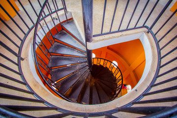 The top view of the spiral staircase with orange wall