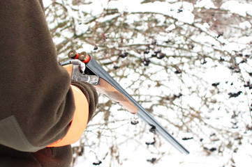 hunting rifle in the hand of the hunter