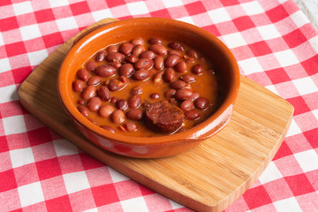 Dish of red beans in clay pot.