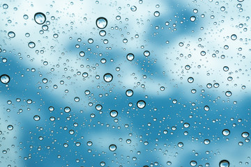 Rain on the window, natural skin of the rain The natural form of rainwater on a sky background.