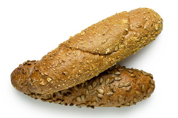 Long whole wheat sunflower seed bread roll and whole wheat sesame seed bread roll isolated on white. Top view.