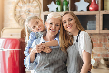 Lovely female family portrait over kitchen background