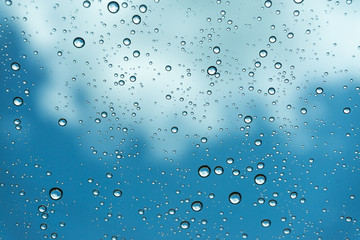 Naklejka na ściany i meble Rain on the window, natural skin of the rain The natural form of rainwater on a sky background.