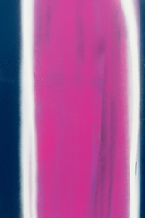 Streaks of blue, white, pink and purple paint on the wall. Background image to insert text.
