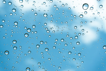 Rain on the window, natural skin of the rain The natural form of rainwater on a sky background.