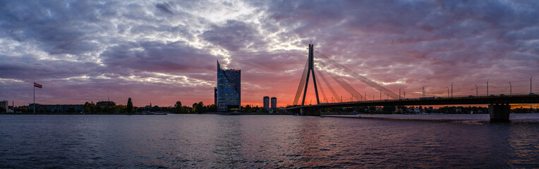 Fototapeta na wymiar panoramic view of Riga city in Latvia. Capital of Latvia at nightfall with red sunset