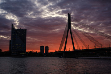 Fototapeta premium panoramic view of Riga city in Latvia. Capital of Latvia at nightfall with red sunset