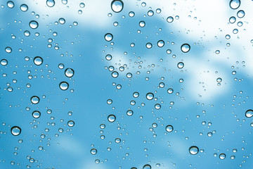 Rain on the window, natural skin of the rain The natural form of rainwater on a sky background.