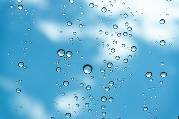 Rain on the window, natural skin of the rain The natural form of rainwater on a sky background.