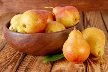 Bright sweet pears still life. Ripe pears on wooden background.