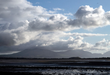 Wales – the northern coastline. A stormy autumn day with angry clouds passing over distant mountains, near Caernarfon.