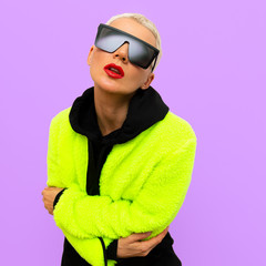 Stylish blonde Model with short hair and trendy sunglasses. Bright clubbing style