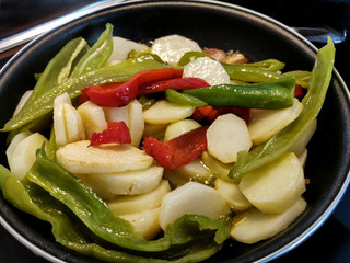Vegetables with potatoes frying in the pan