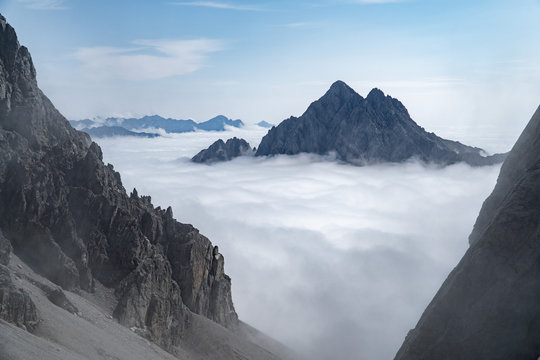 Mountain peaks above clouds, Dolomites, Lienz, Austria