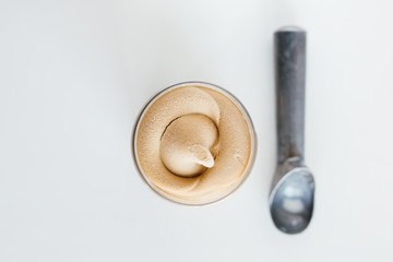 Pint of caramel ice cream , top view, white background