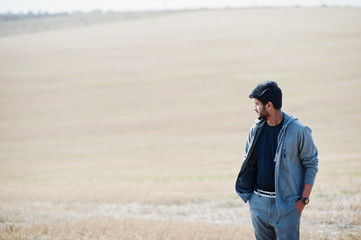 Indian man at casual wear posed at field alone.