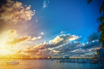 Sun shining over Miami Beach bayfront at sunset