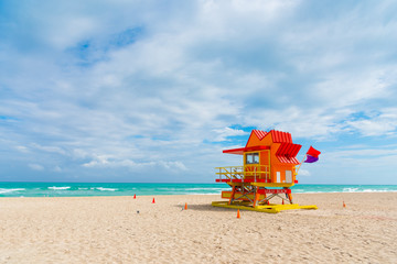 Colorful lifeguard hut under a cloudy sky in Miami Beach