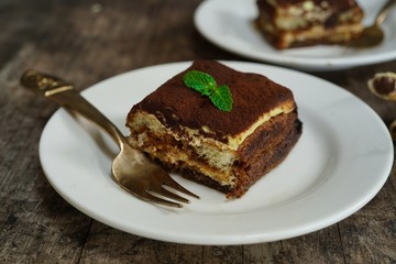 Square slice of Tiramisu cake, selective focus