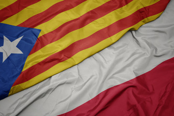 waving colorful flag of poland and national flag of catalonia.
